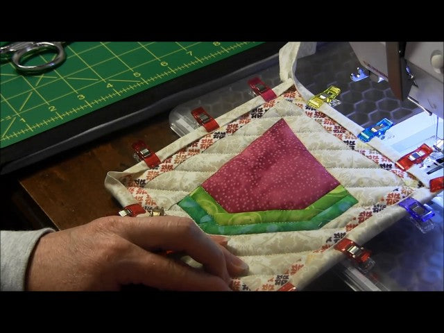 Learn a simple way to machine bind a potholder with a hanging loop
